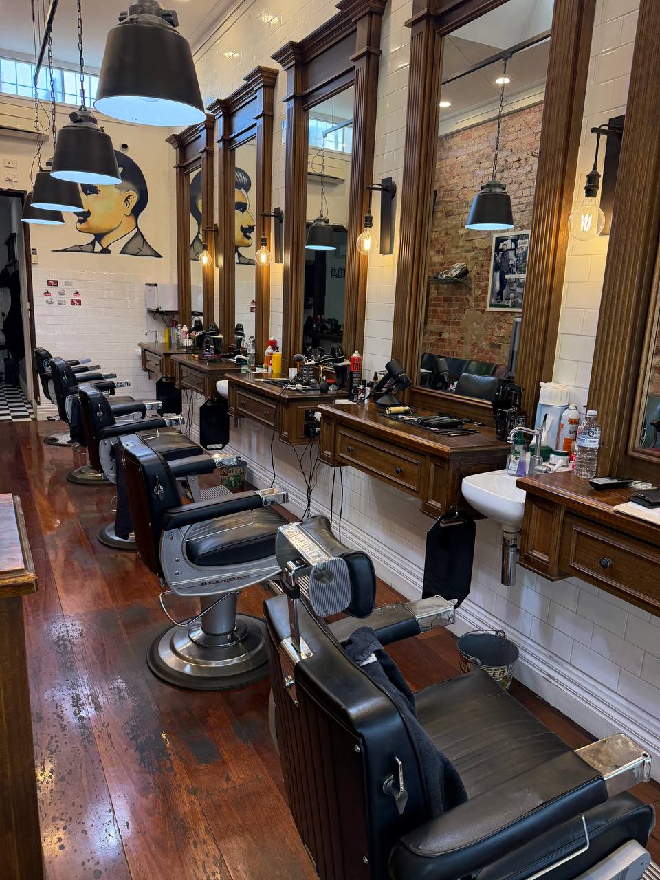Barber chairs and wooden mirrors inside our studio